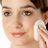 woman applying facial toner