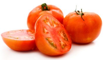 three tomatoes with one cut in half