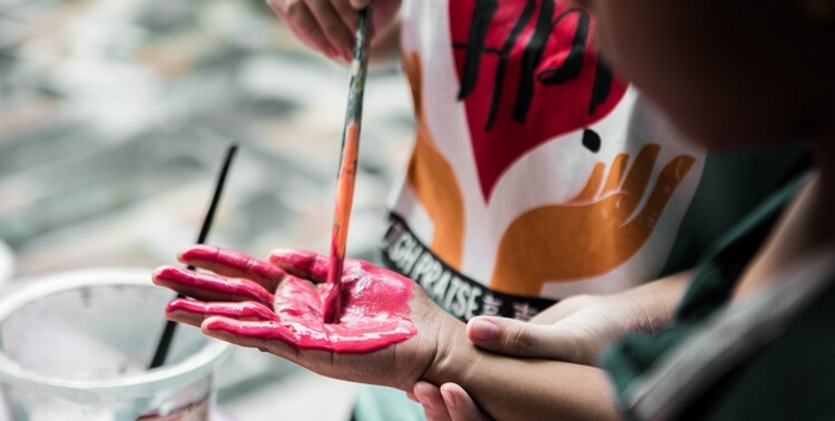 painting a child's hand red