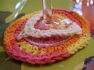 crochet flipflop coaster in multi-colors holding wine glass base