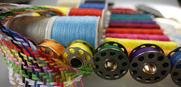 sewing bobbins and multi colored sewing threads