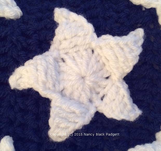 close-up of crocheted star on American flag afghan