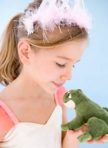little girl dressed as princess holding a frog