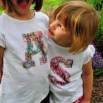 two girls wearing t-shirts decorated with their initials