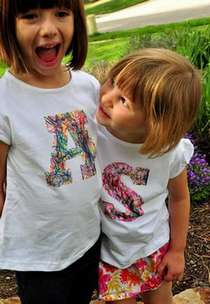 two girls wearing t-shirts decorated with their initials