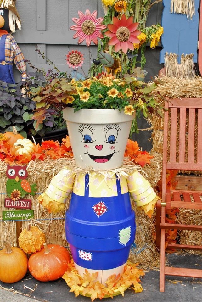 clay pot scarecrow with flowers