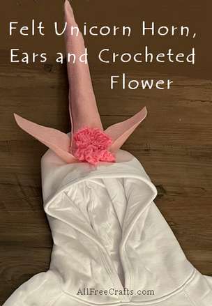felt unicorn horn, ears and crocheted flower on hoodie