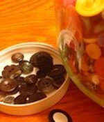 black buttons sorted from a large jar of buttons