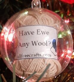 knitter's christmas ornament in clear plastic with mini yarn and quote